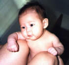 Hum dee dum, just hanging out on top of Daddy's knee (2 months old)